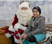 Santa and a young guest at White City Christmas celebration